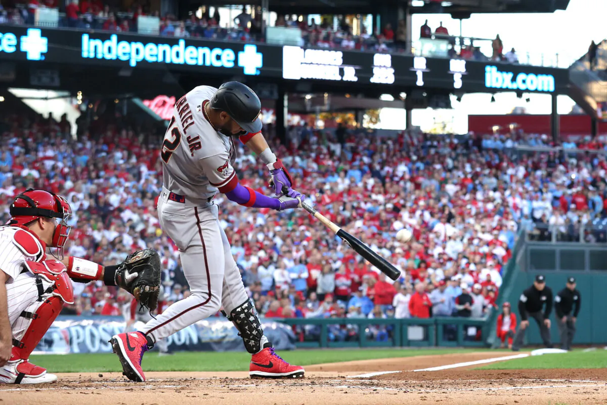 Lourdes Gurriel Jr. (12) of the Arizona Diamondbacks hits a solo home run in the second inning against the Philadelphia Phillies during Game Six of the Championship Series in Philadelphia on Oct. 23, 2023. (Tim Nwachukwu/Getty Images)