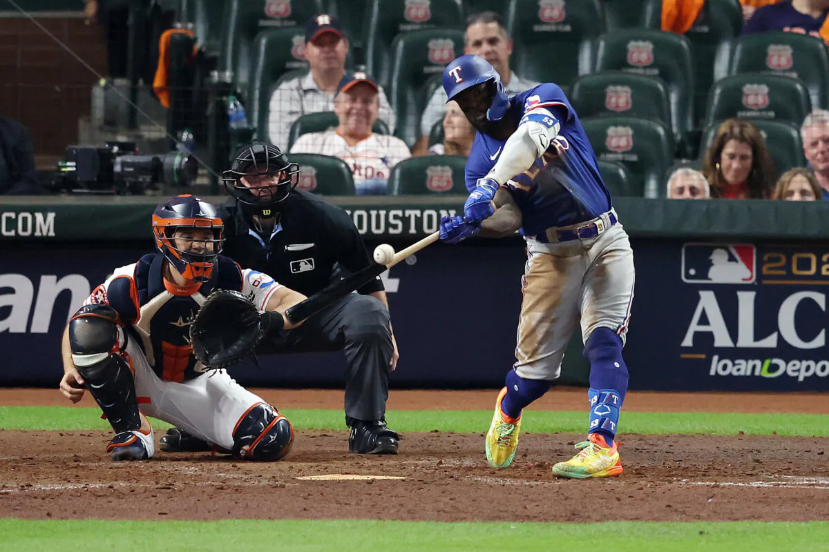 Adolis Garcia (53) of the Texas Rangers hits a solo home run against Jose Urquidy (65) of the Houston Astros during the eighth inning in Game Seven of the American League Championship Series at Minute Maid Park in Houston on Oct. 23, 2023. (Rob Carr/Getty Images)