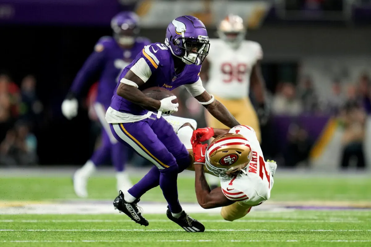 Minnesota Vikings wide receiver Jordan Addison (3) breaks a tackle by San Francisco 49ers cornerback Charvarius Ward (7) during a 60-yard touchdown reception in the first half of an NFL football game in Minneapolis on Oct. 23, 2023. (Abbie Parr/AP Photo)