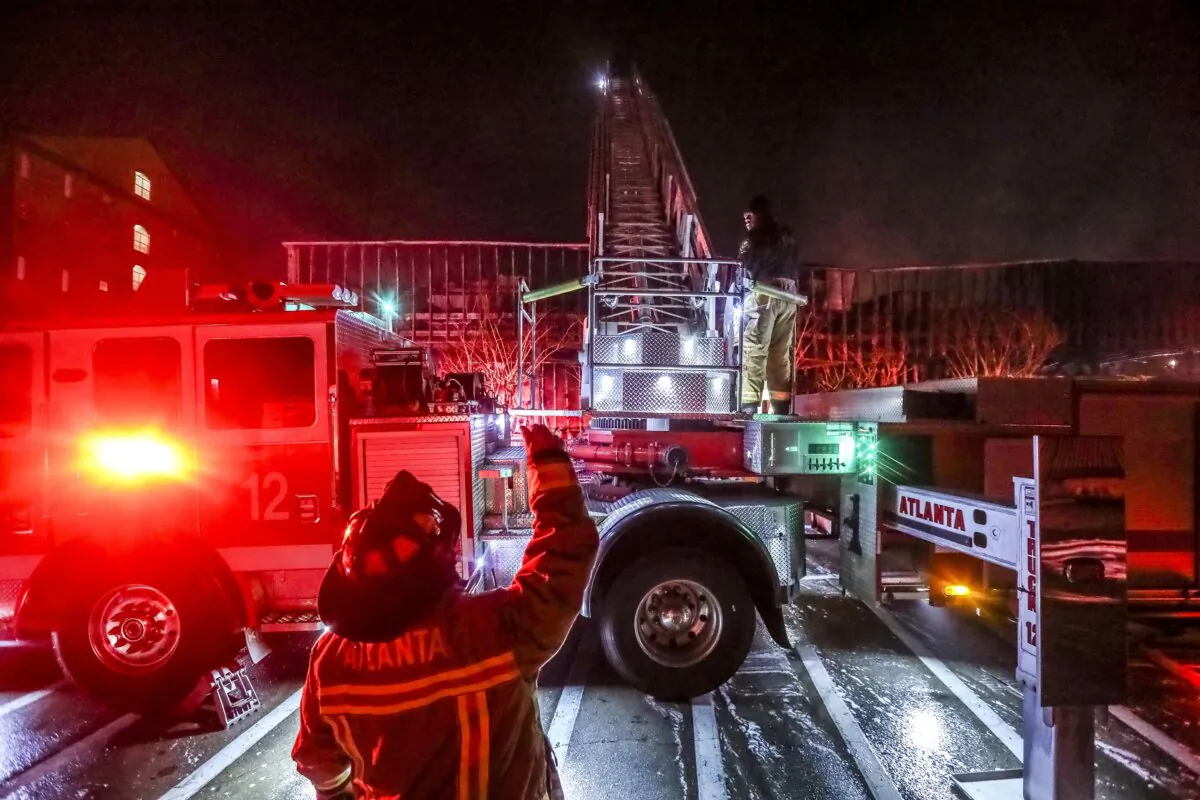 Firefighters work at the scene of a fast-moving fire in Atlanta on Feb. 10, 2021. (John Spink/Atlanta Journal-Constitution via AP)