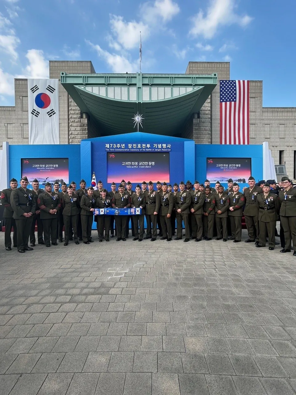 Members of U.S. Marine Corps Forces Korea pose in front of the stage following the 73rd Commemoration of the Battle of the Chosin Reservoir, in Seoul, South Korea, on Oct. 12, 2023. (1st Lt. Tyler Judd, U.S. Marine Corps)