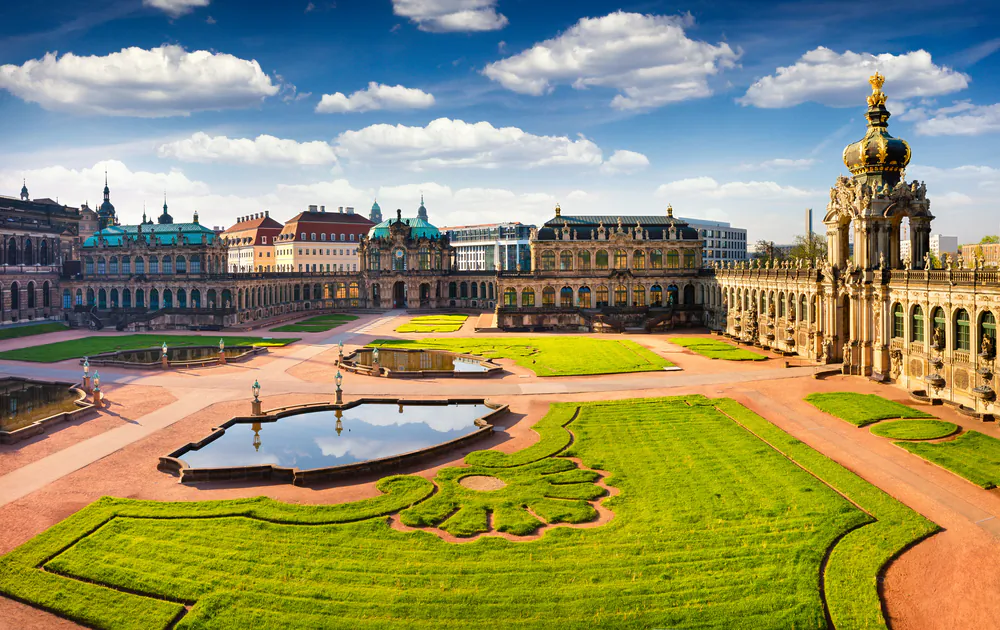 The palace is surrounded by geometric Baroque gardens. Named after the fortress that previously stood there, the vast courtyard comprises symmetric parquets, water features, and Baroque buildings, with carved sculptures. (Andrew Mayovskyy/Shutterstock)
