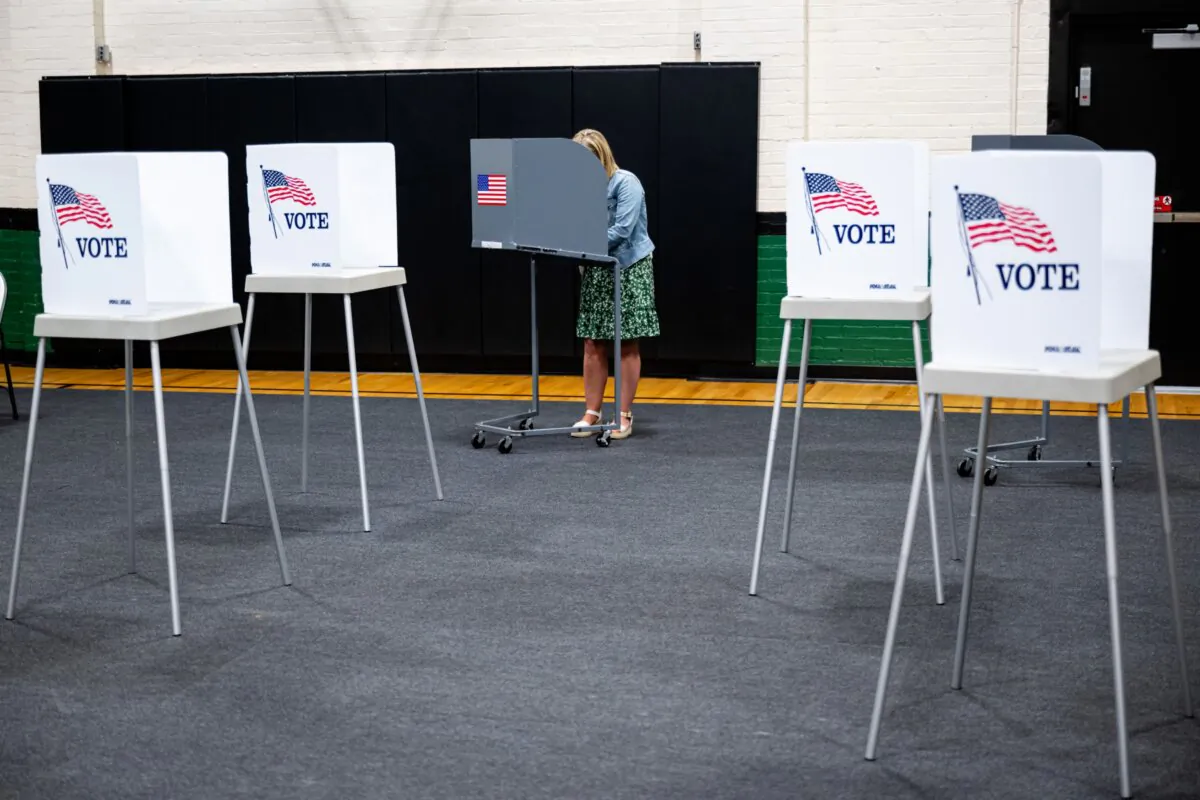 A voter casts a ballot in the Kentucky primary elections in the Simpsonville Community Gym, in Simpsonville, Ky., on May 16, 2023. (Jon Cherry/Getty Images)