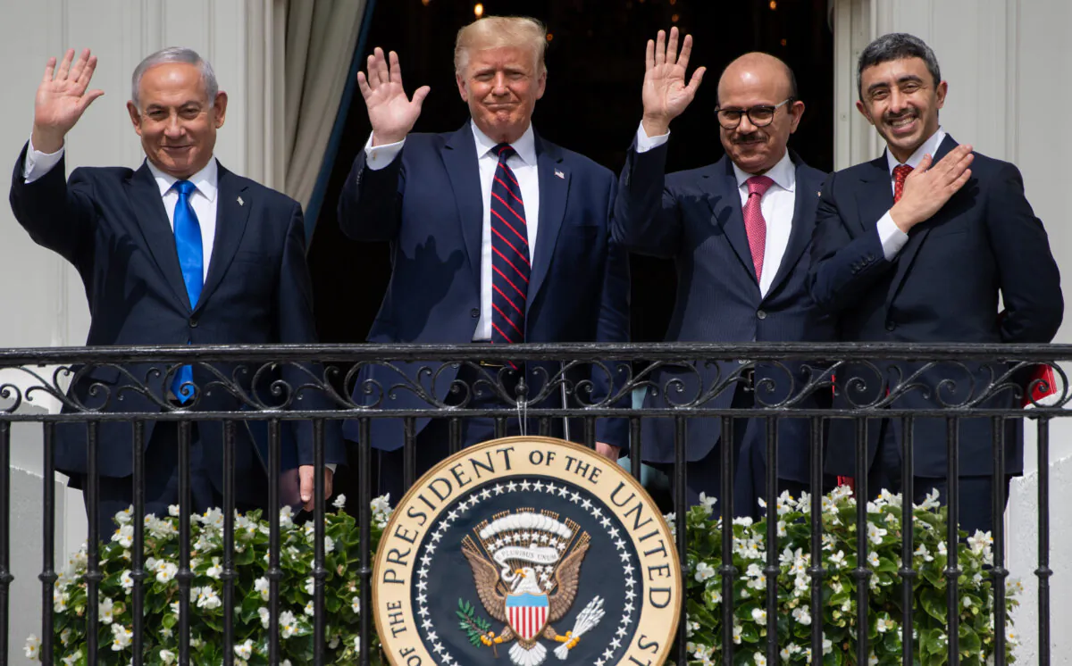 (L–R) Israeli Prime Minister Benjamin Netanyahu, U.S. President Donald Trump, Bahrain Foreign Minister Abdullatif al-Zayani, and UAE Foreign Minister Abdullah bin Zayed Al-Nahyan wave from the Truman Balcony at the White House after signing the Abraham Accords, in which Bahrain and the United Arab Emirates recognized Israel, on Sept. 15, 2020. (Saul Loeb/AFP via Getty Images)