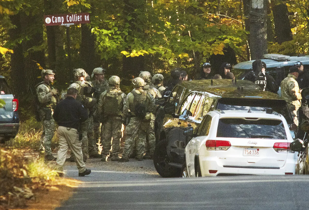 Massachusestts State Police troopers gather at the intersection of Kelton St. and Camp Collier Road in Gardner, Mass., on Oct. 24, 2023. (Rick Cinclair/Worcester Telegram & Gazette via AP)