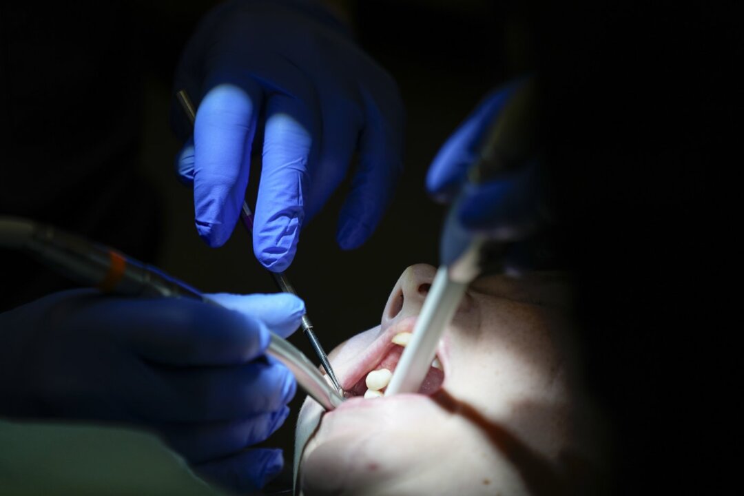 A dentist works on a patient in Nashville, Tenn during a clinic visit on Sept. 7, 2023. (The Canadian Press/AP-George Walker IV)