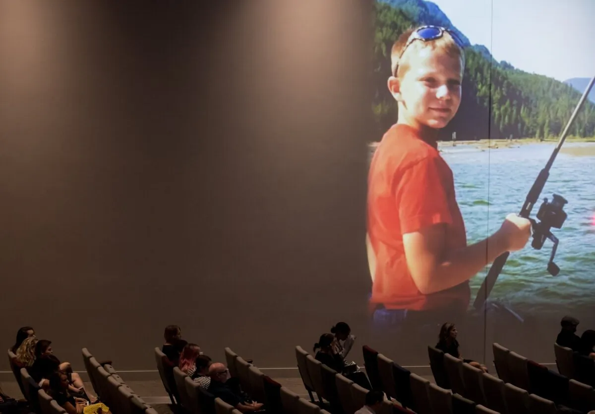 A photo of Carson Crimeni is projected on a wall as people listen during a celebration of life for the late 14-year-old in Langley, B.C., on Aug. 29, 2019. (The Canadian Press/Darryl Dyck)