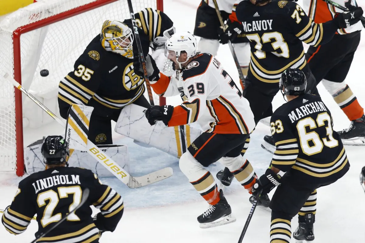 Anaheim Ducks' Sam Carrick (39) celebrates after the tying goal by Troy Terry against Boston Bruins' Linus Ullmark (35) during the third period of an NHL hockey game in Boston on Oct. 26, 2023. (AP Photo/Michael Dwyer)