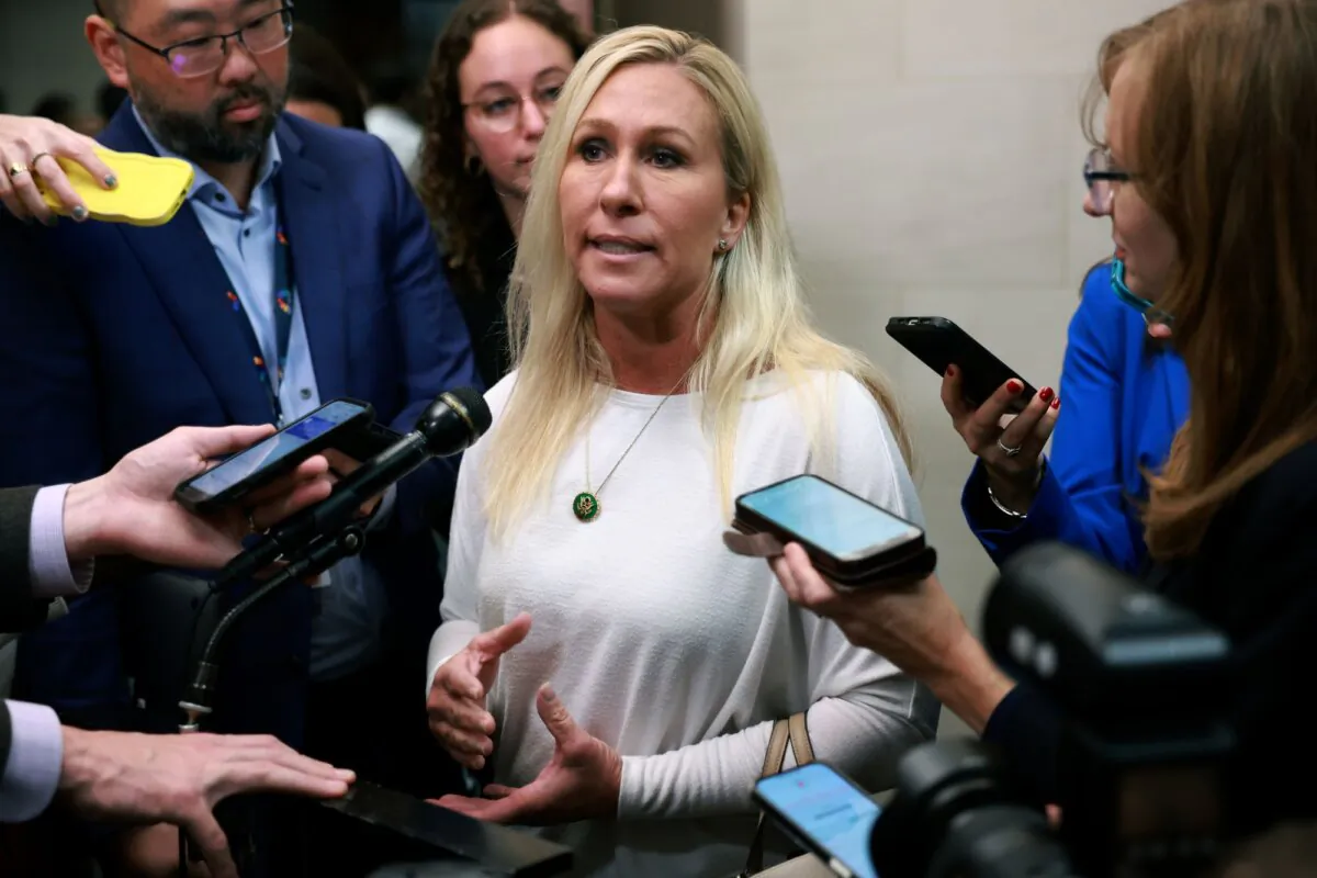 Rep. Marjorie Taylor Greene (R-Ga.) speaks to reporters as House Republicans hold a caucus meeting at the Longworth House Office Building in Washington on Oct. 13, 2023. (Joe Raedle/Getty Images)