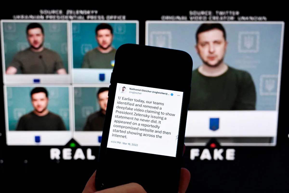 A phone displaying a statement from the head of security policy at Meta, in front of a screen displaying a deepfake video of Ukrainian President Volodymyr Zelensky calling on his soldiers to lay down their weapons, in Washington on Jan. 30, 2023. (Olivier Douliery/AFP via Getty Images)