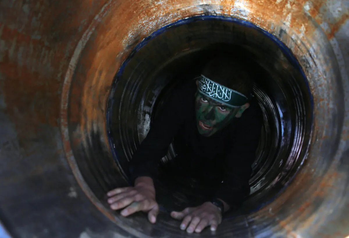 A Palestinian youth crawls in a tunnel during a graduation ceremony for a training camp run by the Hamas terror group, in Gaza, on Jan. 29, 2015. (Said Khatib/AFP via Getty Images)