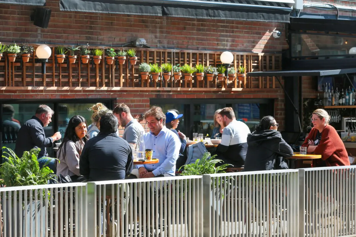 Patrons dine on a patio on King Street in Toronto on Sept. 28, 2021. A new report says restaurants are ushering in higher prices, shorter menus, smaller portion sizes, and reduced hours in a bid to survive inflation and labour shortages. (The Canadian Press/Evan Buhler)