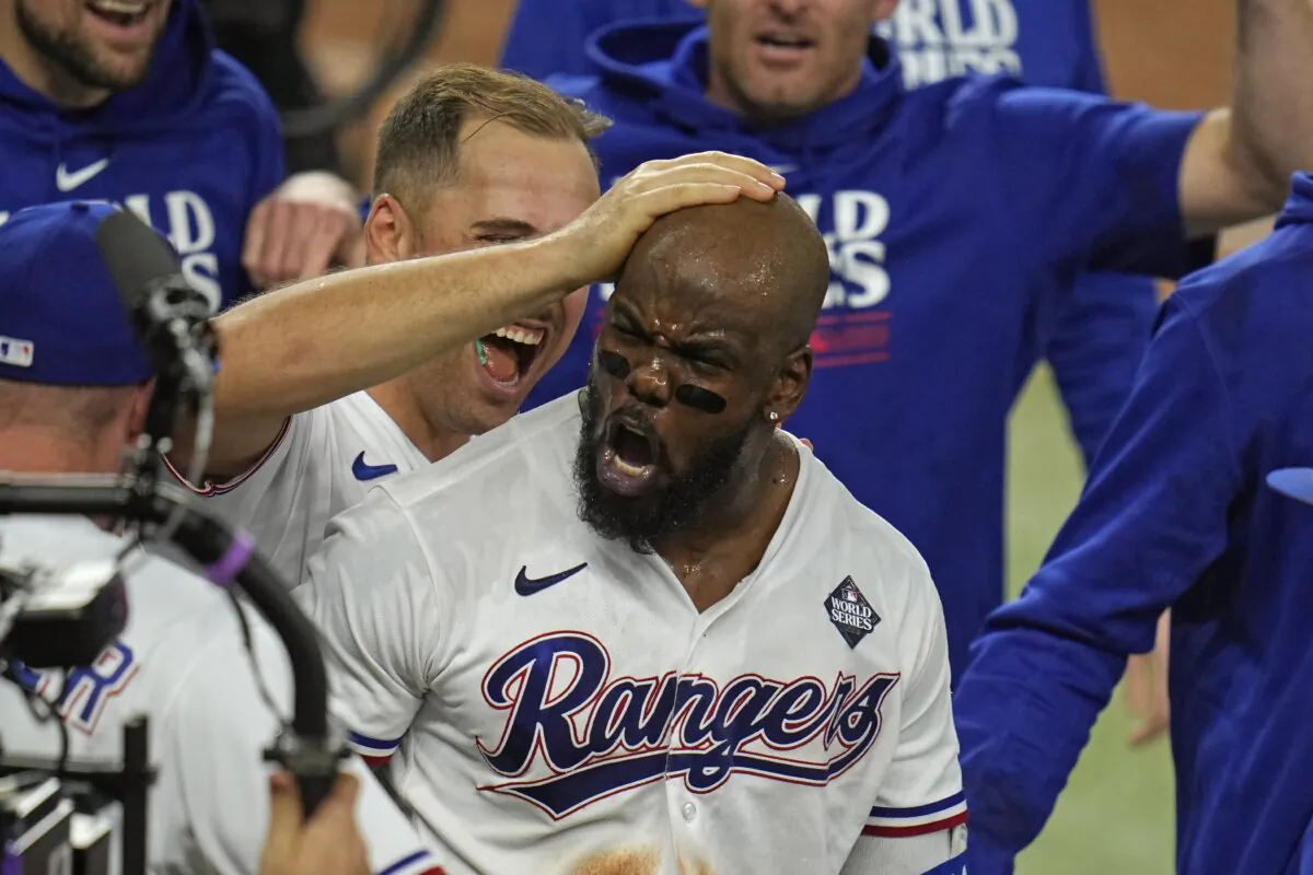 Texas Rangers' Adolis Garcia celebrates with teammates after hitting a game-winning home run against the Arizona Diamondbacks during the 11th inning in Game 1 of the baseball World Series in Arlington, Texas, on Oct. 27, 2023. (Julio Cortez/AP Photo)