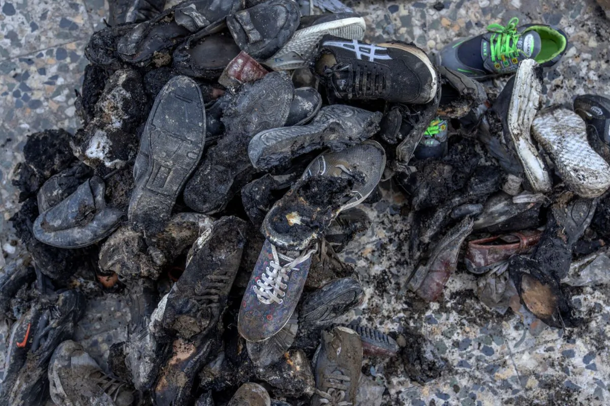 Burnt shoes from an explosion in a sports club are on the ground, in the west of Kabul, Afghanistan, on Oct. 27, 2023. (Ebrahim Noroozi/AP)