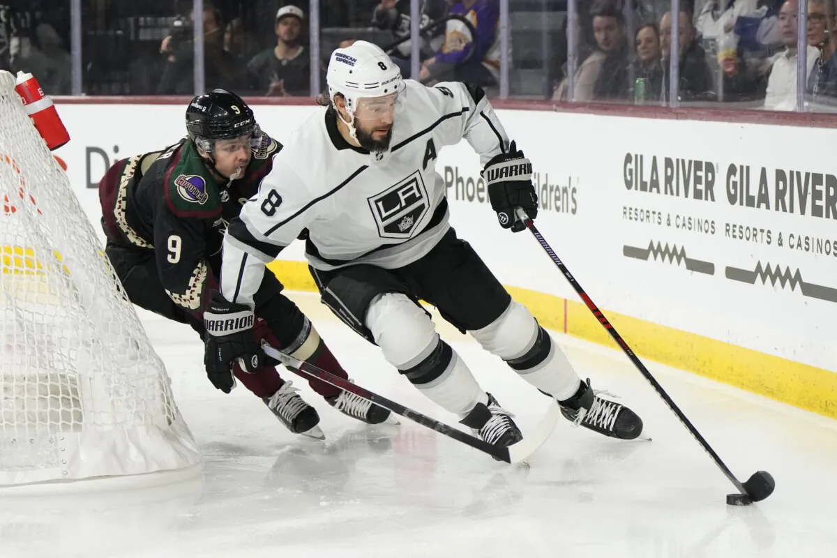 Los Angeles Kings defenseman Drew Doughty (8) shields the puck from Arizona Coyotes right wing Clayton Keller (9) in the second period during an NHL hockey game in Tempe, Ariz., on Oct. 27, 2023. (Rick Scuteri/AP Photo)