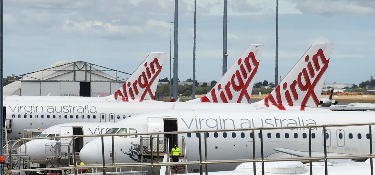 A man in high-vis can be see debarking from a Virgin Airlines plane at Perth Airport, Australia, on Oct. 26, 2023. (Susan Mortimer/The Epoch Times)
