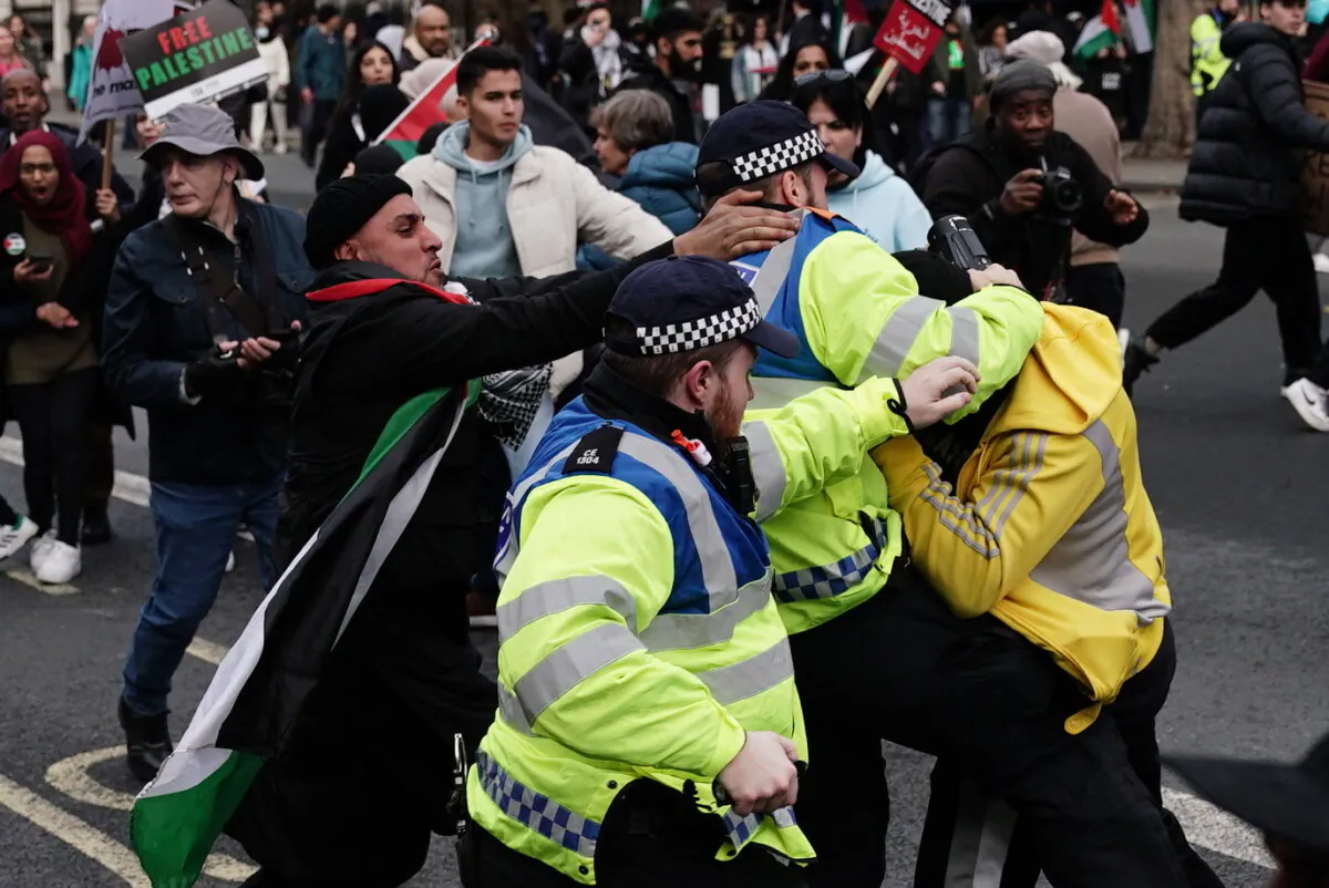 Police Officers clash with rival supporters as protesters walk past the Cenotaph on Whitehall during a pro-Palestine march organised by Palestine Solidarity Campaign in central London on Oct. 28, 2023. (Jordan Pettitt/PA)
