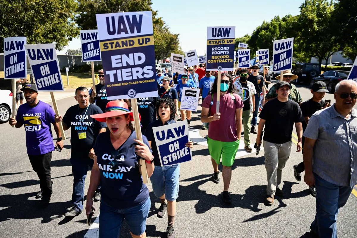 Labor supporters and members of the United Auto Workers union (UAW) Local 230 march along a picket line during a strike outside of the Stellantis Chrysler Los Angeles Parts Distribution Center in Ontario, Calif., on Sept. 26, 2023. (Patrick T. Fallon/AFP via Getty Images)