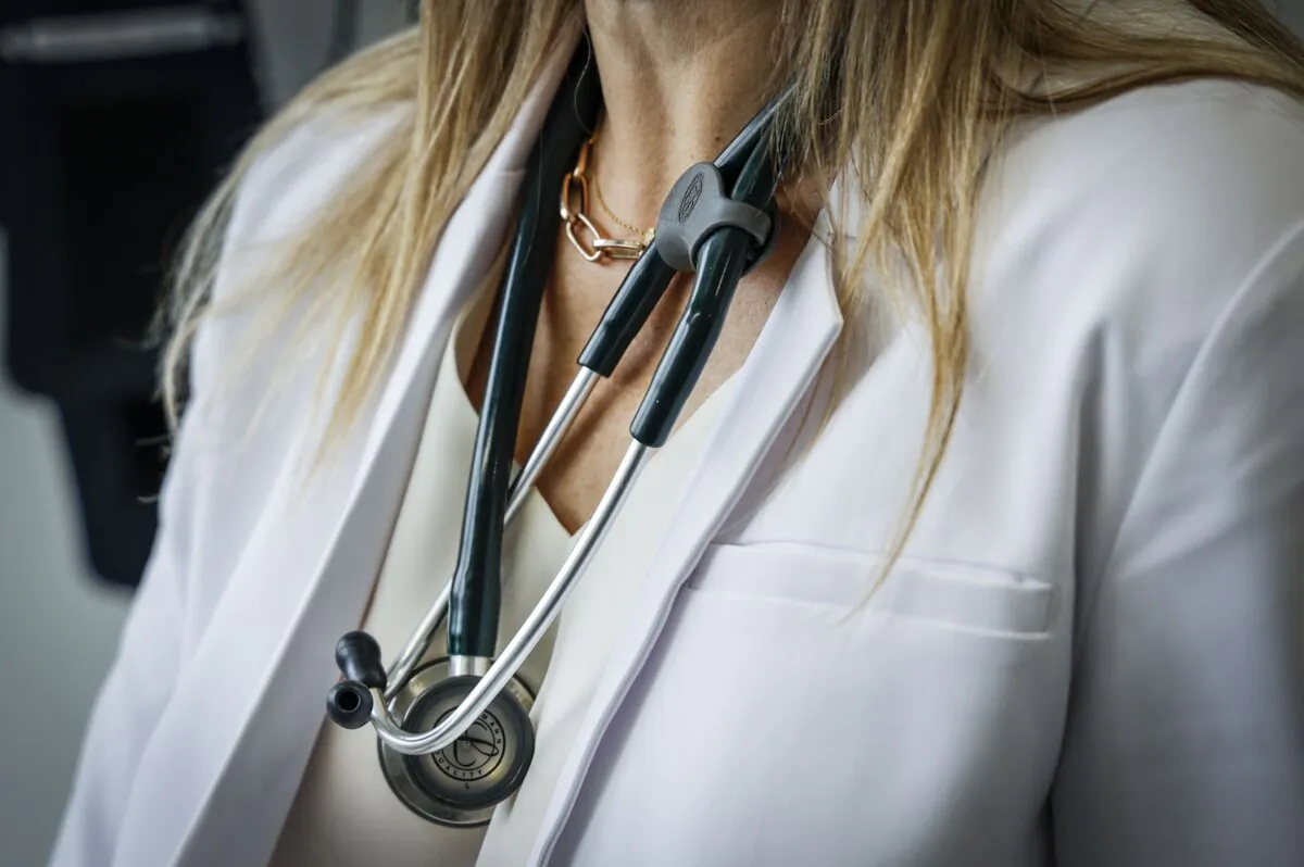 A doctor wears a lab coat and stethoscope at a health clinic in Calgary on July 14, 2023. (The Canadian Press/Jeff McIntosh)