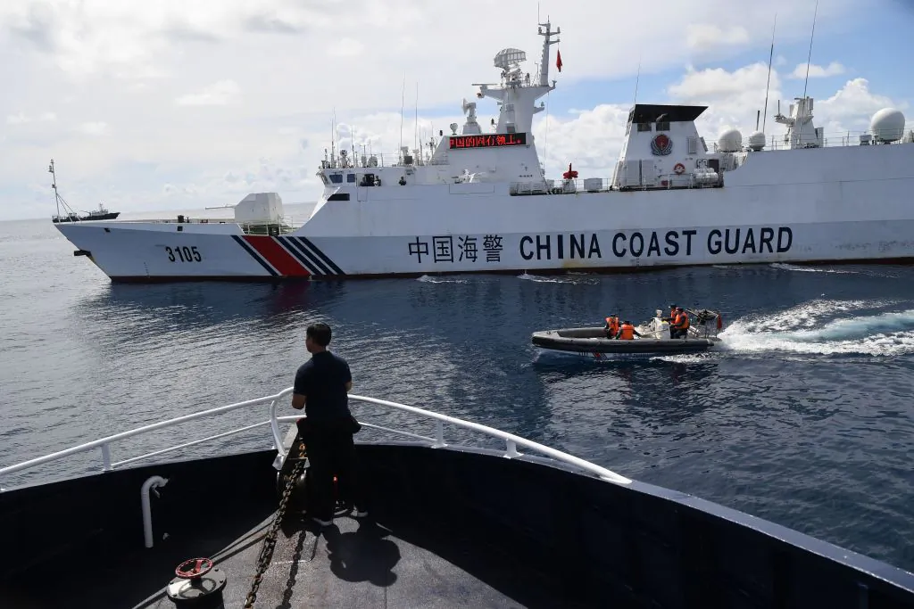 A Chinese coast guard ship blocks a Philippine Bureau of Fisheries and Aquatic Resources' (BFAR) ship as it nears the Chinese-controlled Scarborough Shoal in the disputed South China Sea, on Sept. 22, 2023. (Ted Aljibe/AFP via Getty Images)