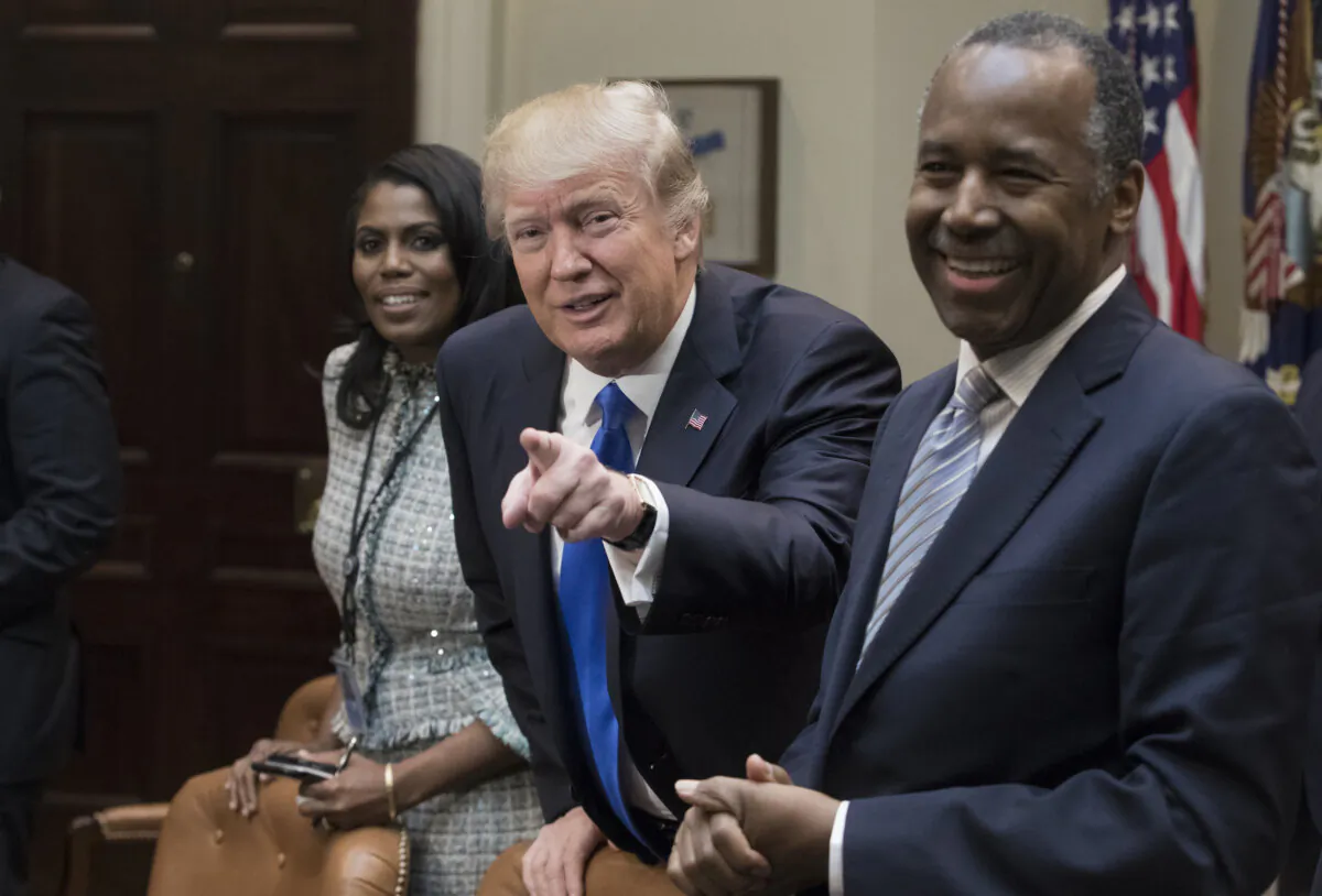 Former President Donald Trump holds an African American History Month listening session attended by nominee to lead the Department of Housing and Urban Development (HUD) Ben Carson (right), Director of Communications for the Office of Public Liaison Omarosa Manigault (left) and other officials in the Roosevelt Room of the White House in Washington on Feb. 1, 2017. (Michael Reynolds - Pool/Getty Images)
