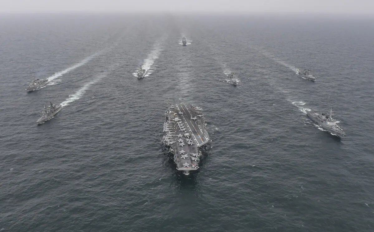 South Korean Navy's destroyer Yulgok Yi I (R), U.S. Navy's aircraft carrier USS Nimitz (C), and Japan Maritime Self-Defense Force's Umigiri (L) sail in formation during a joint naval exercise in international waters off South Korea's southern island of Jeju on April 4, 2023. (South Korean Defense Ministry via Getty Images)