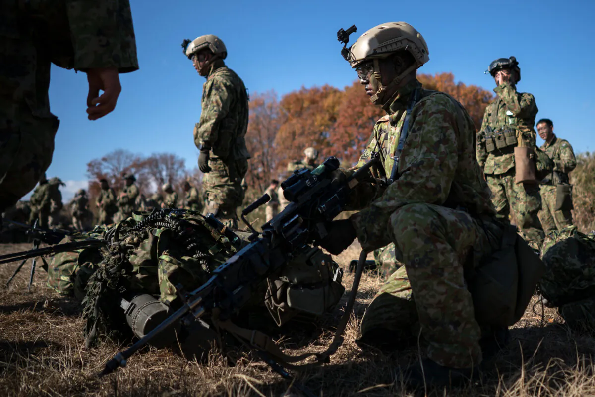 Members of the Japan Ground Self-Defense Force and soldiers of the British Army take part in the joint field exercise "Vigilant Isles 22" at Soumagahara Maneuvering Ground in Shinto Village, Gunma, Japan, on Nov. 26, 2022. (Tomohiro Ohsumi/Getty Images)