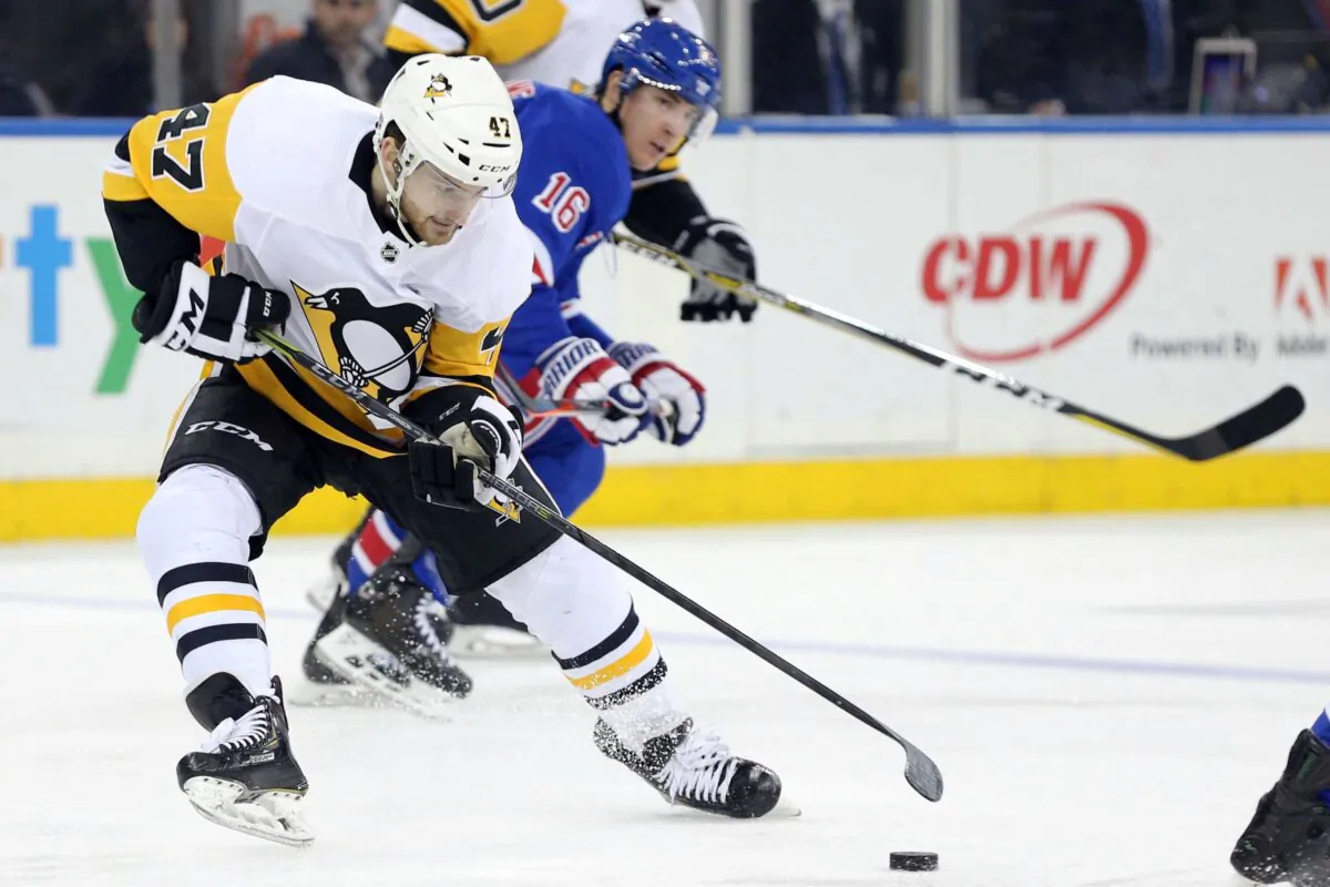 Pittsburgh Penguins center Adam Johnson (47) plays the puck against New York Rangers center Ryan Strome (16) during the third period at Madison Square Garden in New York on Mar 25, 2019. (Brad Penner/USA TODAY Sports via Reuters)