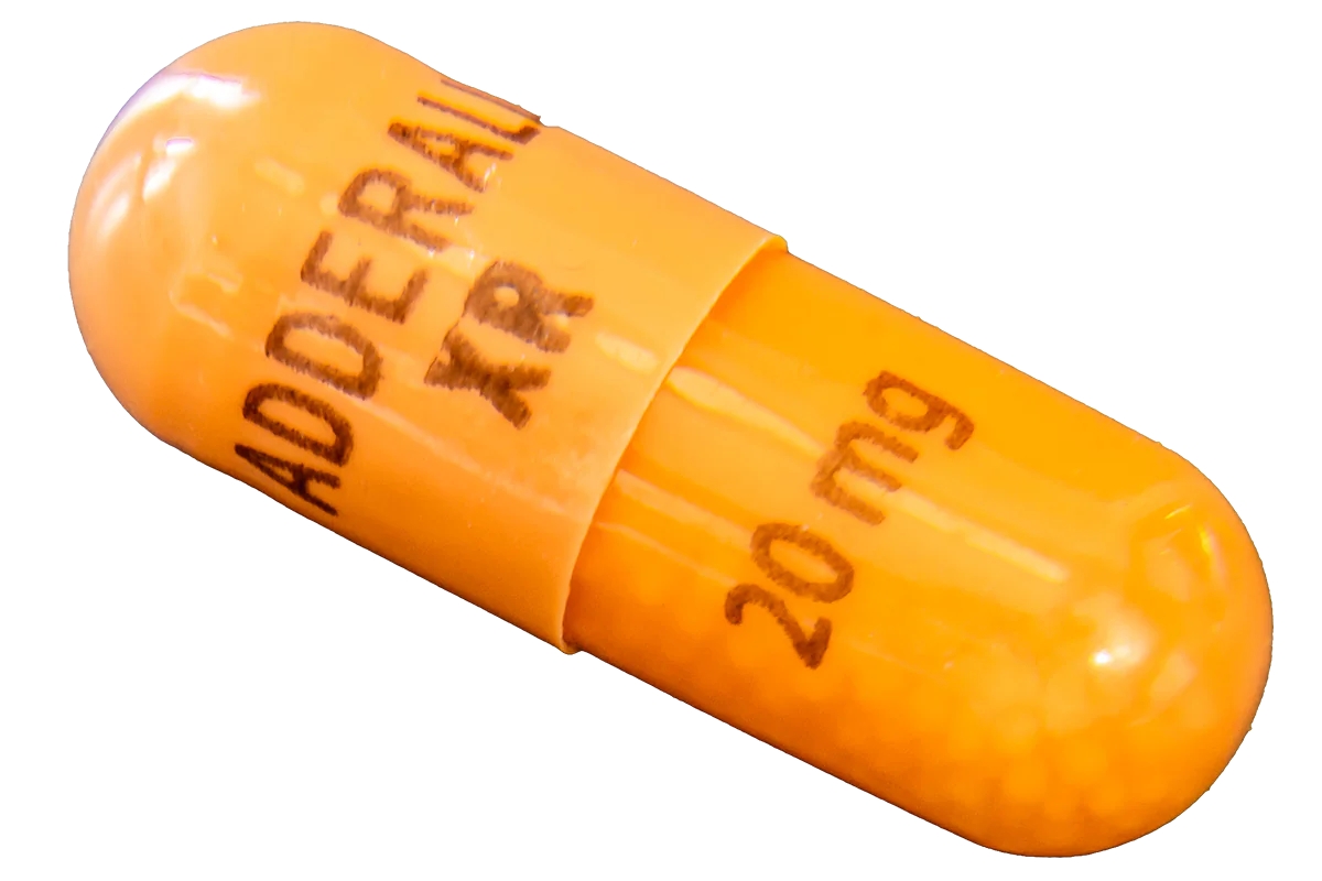 OTTAWA, ON, CANADA - NOVEMBER 13, 2019: Single 20 mg capsule of Adderall XR, a mixed amphetamine salts stimulant used in psychiatric medicine to treat ADD, ADHD and narcolepsy, on a gray surface.
