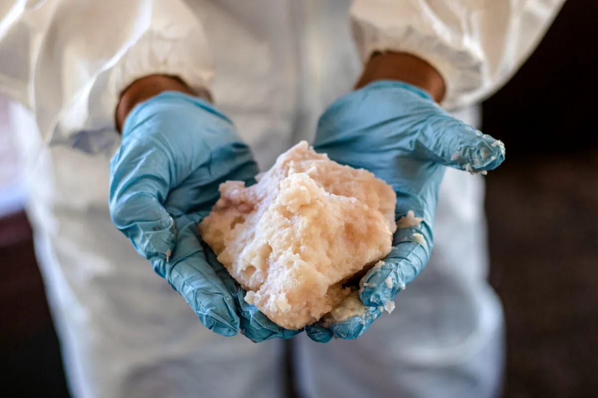 A Mexican Army expert shows crystal meth paste at a clandestine laboratory near la Rumorosa town in Tecate, Baja California state, Mexico on August 28, 2018.  (GUILLERMO ARIAS/AFP via Getty Images)