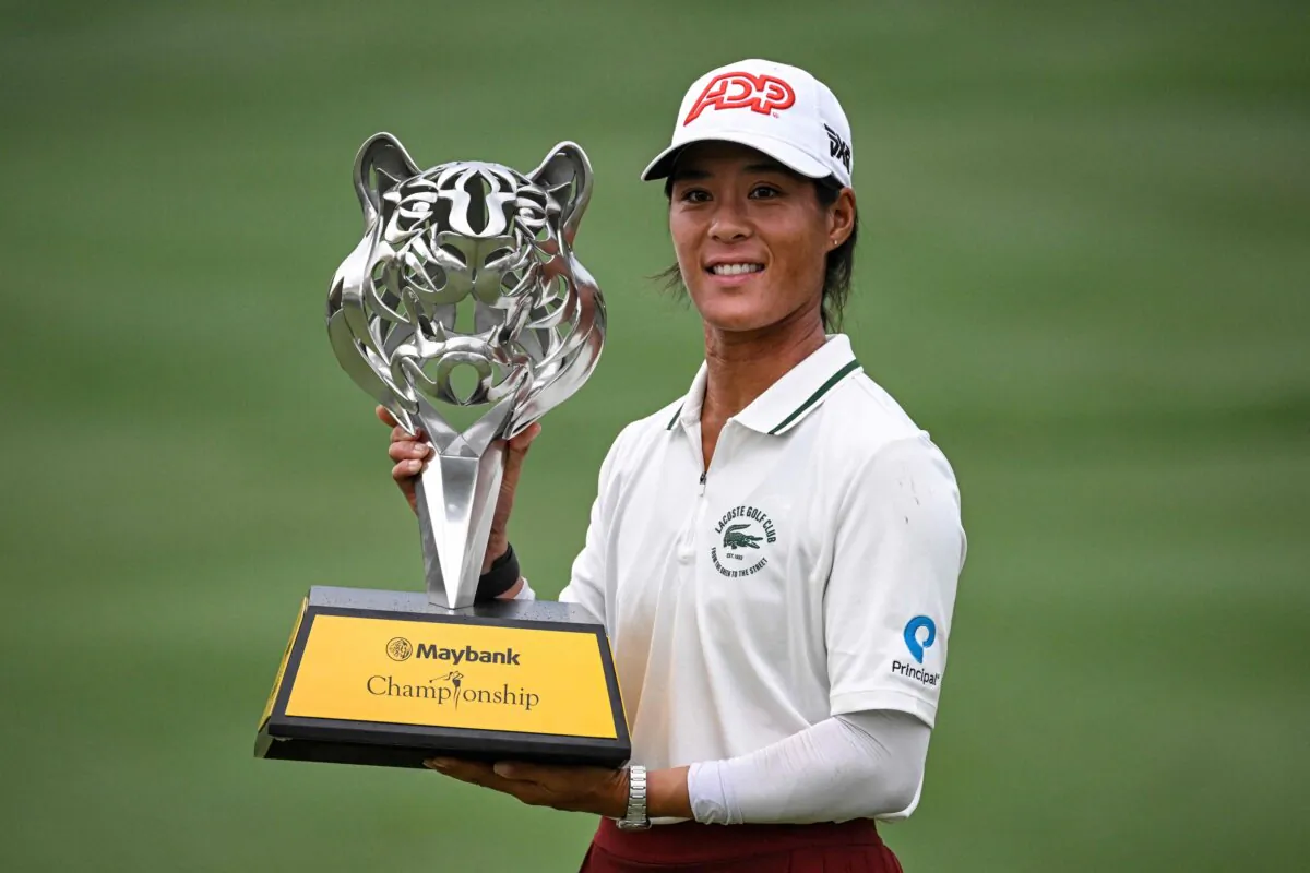 France's Celine Boutier celebrates with the trophy after winning in the final round of the Maybank Championship golf tournament in Kuala Lumpur on Oct. 29, 2023. (Mohd Rasfan/AFP via Getty Images)