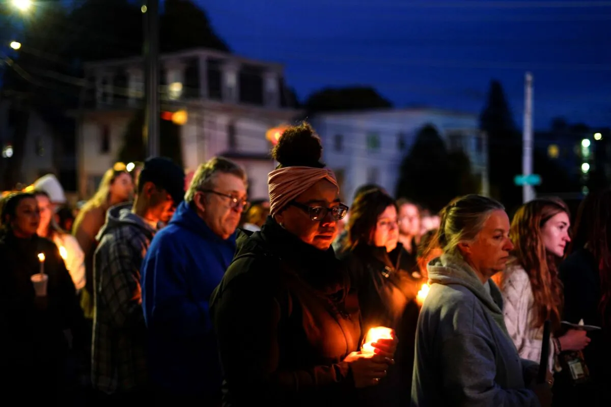 People gather at a vigil for the victims of mass shootings on Oct. 25, outside the Basilica of Saints Peter and Paul in Lewiston, Maine, on Oct. 29, 2023. (Matt Rourke/AP Photo)