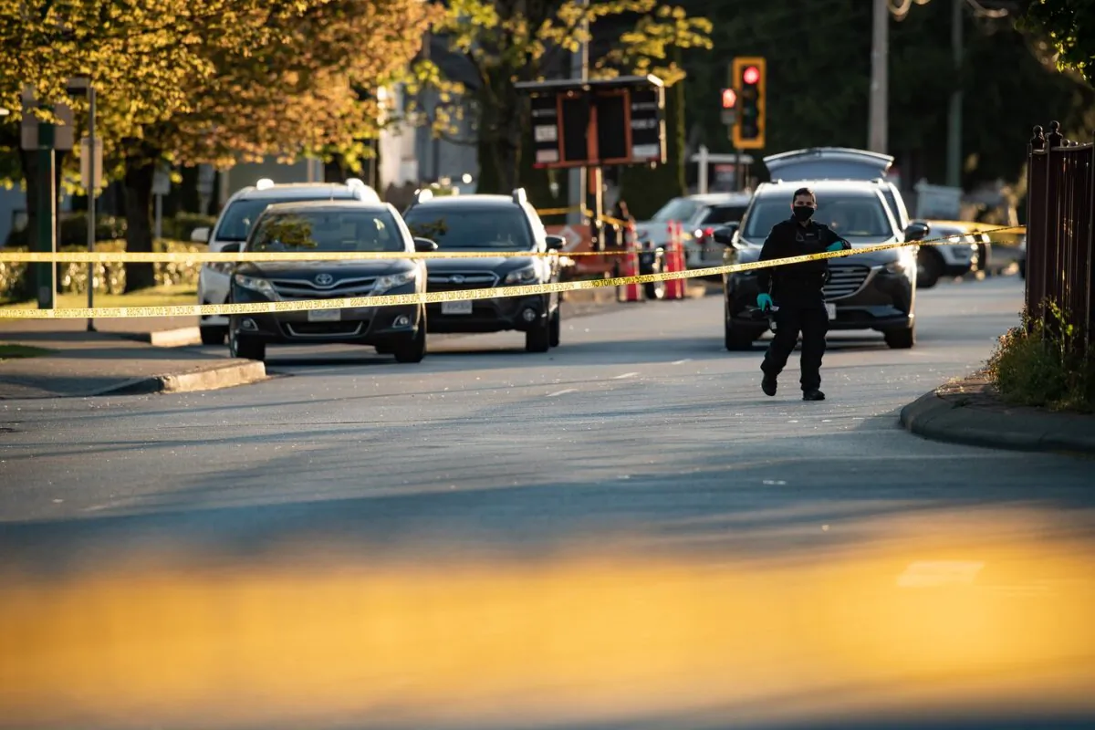 A police officer works at the scene of a fatal shooting outside a shopping centre, in Delta, B.C., on May 1, 2021. (The Canadian Press/Darryl Dyck)