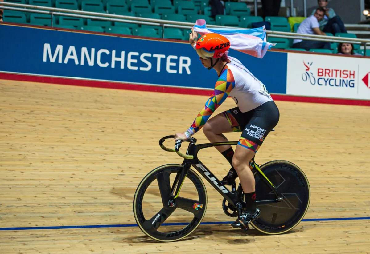 Canadian cyclist Rachel McKinnon carries a transgender pride flag after winning the F35-39 Sprint Final during the 2019 UCI Track Cycling World Masters Championship, in Manchester on Oct. 19, 2019. (Oli Scarff/AFP via Getty Images)