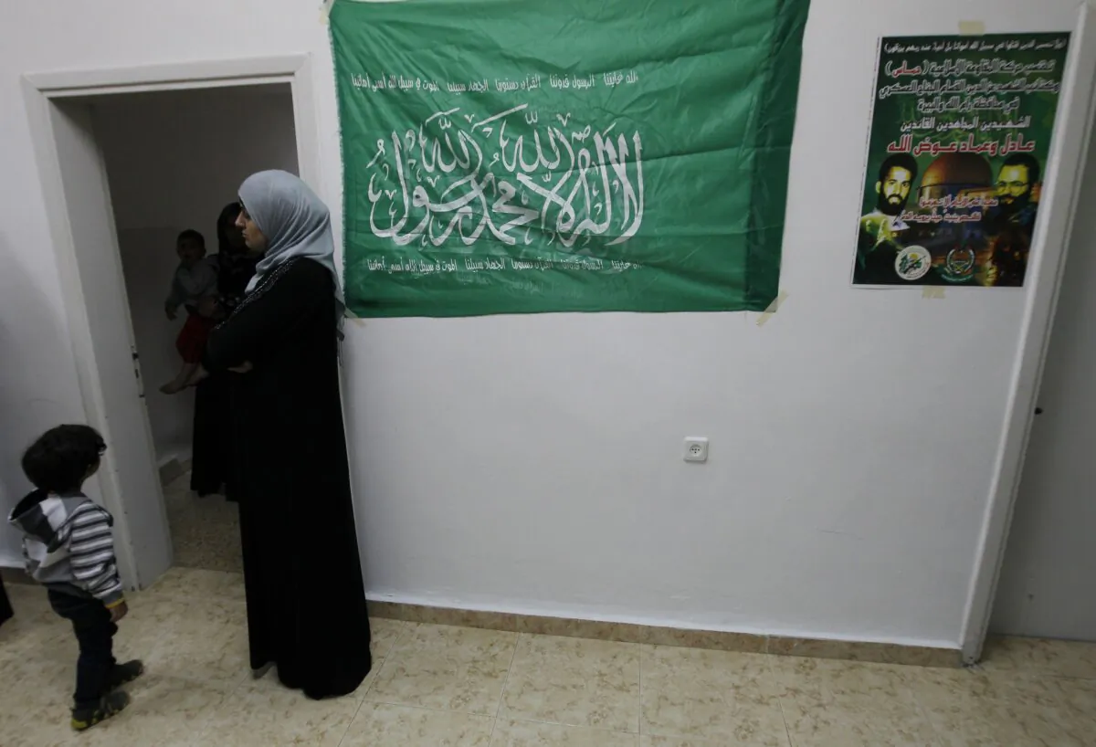 A woman stands next to a Hamas flag in Al-Bireh, located in West Bank, in a file photo.(Abbas Momani/AFP via Getty Images)