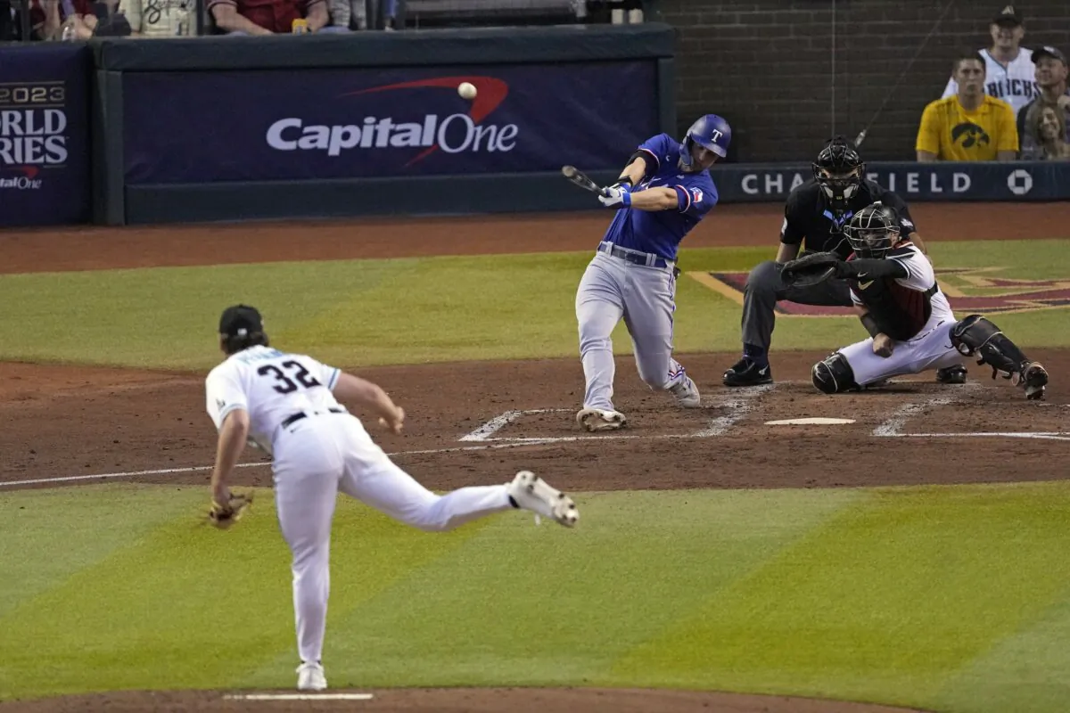 Texas Rangers' Corey Seager hits a two-run home run off Arizona Diamondbacks starting pitcher Brandon Pfaadt (32) during the third inning in Game 3 of the baseball World Series in Phoenix on Oct. 30, 2023. (Ross D. Franklin/AP Photo)