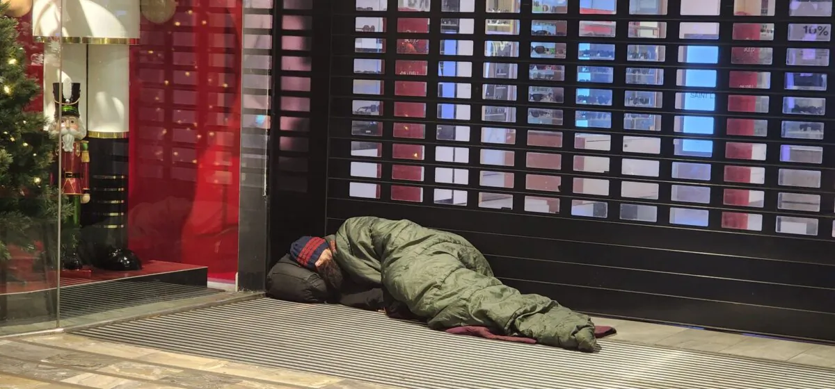 A homeless man sleeps at a shop front in central Melbourne, Australia, on Oct. 28, 2023. (Susan Mortimer/The Epoch Times)