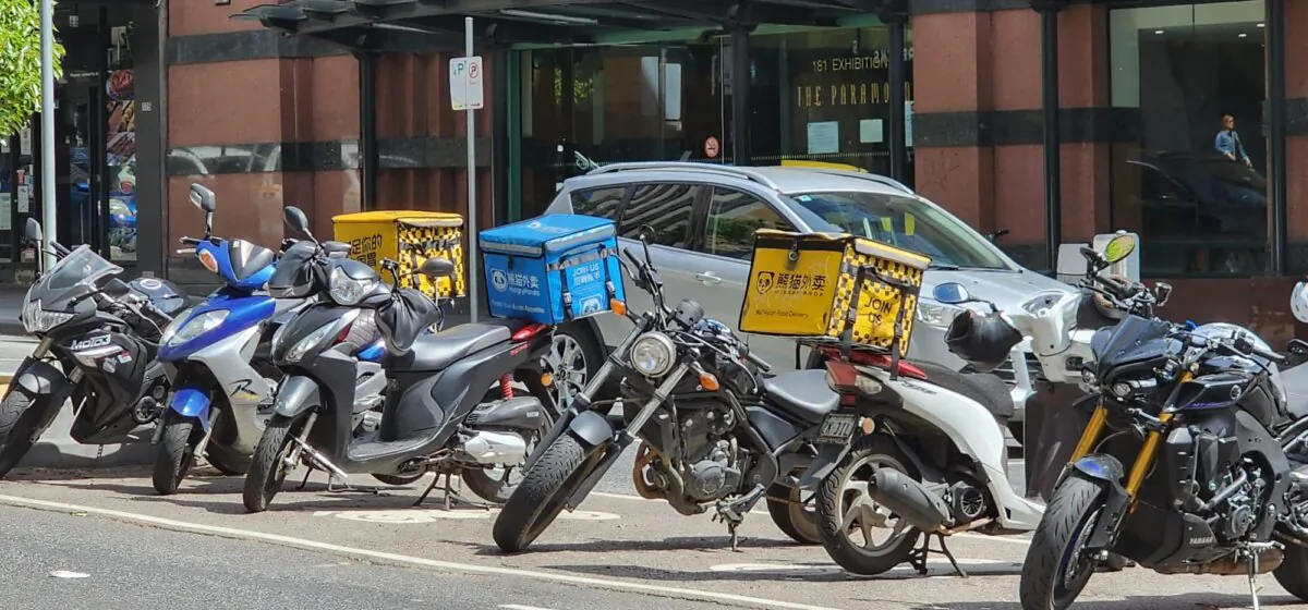 Food delivery scooters can be seen in Melbourne, Australia, on Oct. 28, 2023. (Susan Mortimer/The Epoch Times)