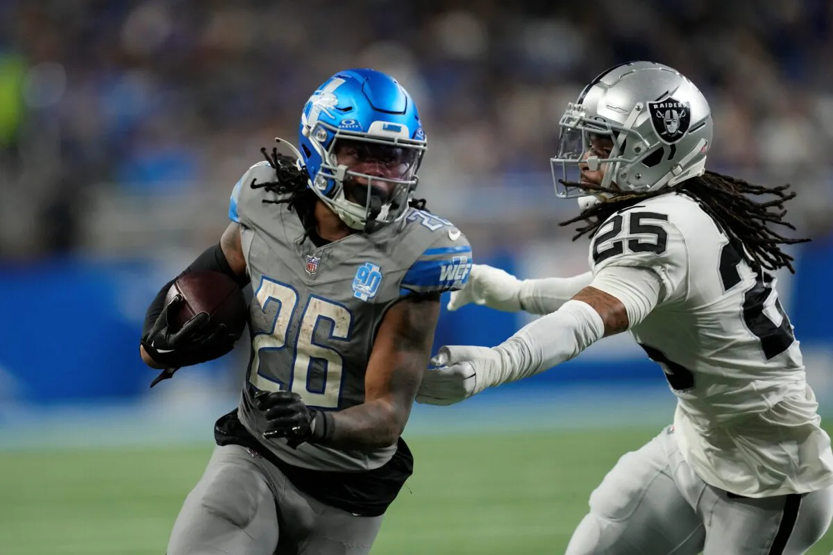 Detroit Lions running back Jahmyr Gibbs (26) rushes against the defense of Las Vegas Raiders safety Tre'von Moehrig (25) during the second half of an NFL football game in Detroit on Oct. 30, 2023. (Paul Sancya/AP Photo)
