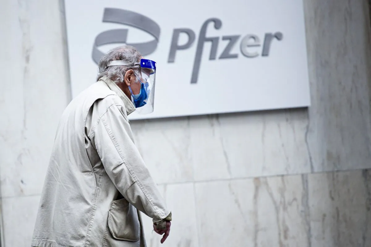 A man walks past the Pfizer headquarters in New York on March 11, 2021. (Kena Betancur/AFP/Getty Images)