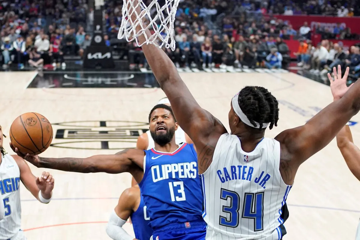 Los Angeles Clippers forward Paul George (L) drives to the basket as Orlando Magic center Wendell Carter Jr. defends during the first half of an NBA basketball game in Los Angeles on Oct. 31, 2023. (Mark J. Terrill/AP Photo)