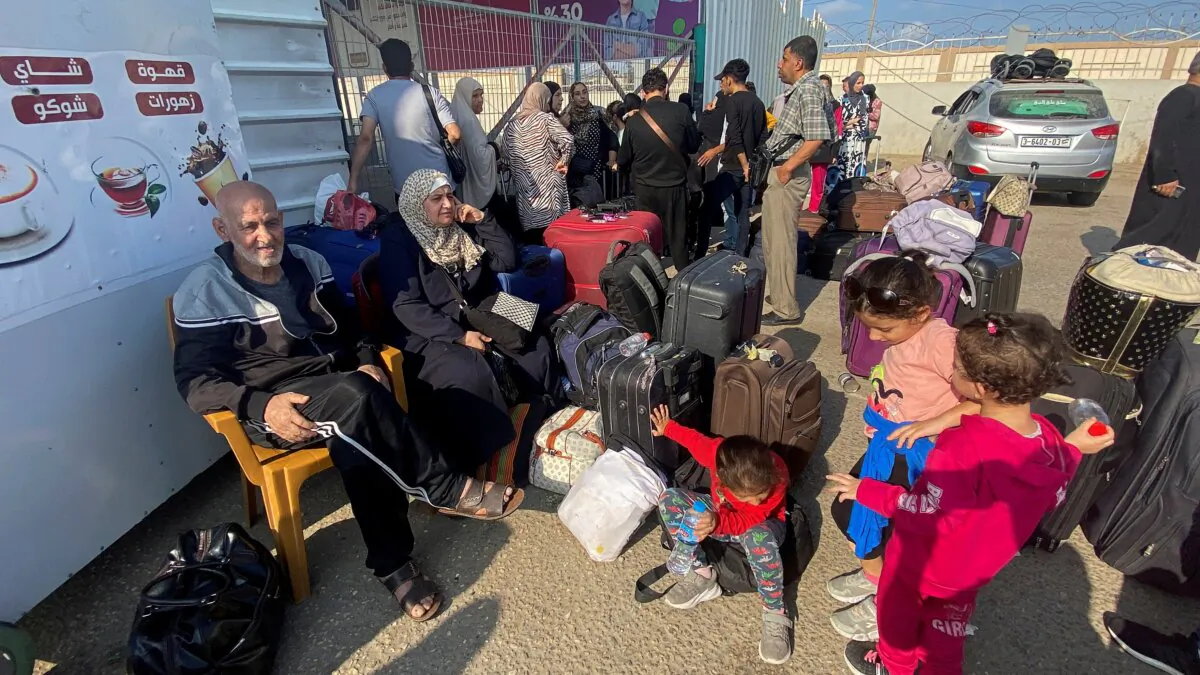 Palestinians with dual citizenship wait outside the Rafah border crossing with Egypt, in the hope of getting permission to leave Gaza, in Rafah in the southern Gaza Strip, on Nov. 1, 2023. (Arafat Barbakh/Reuters)