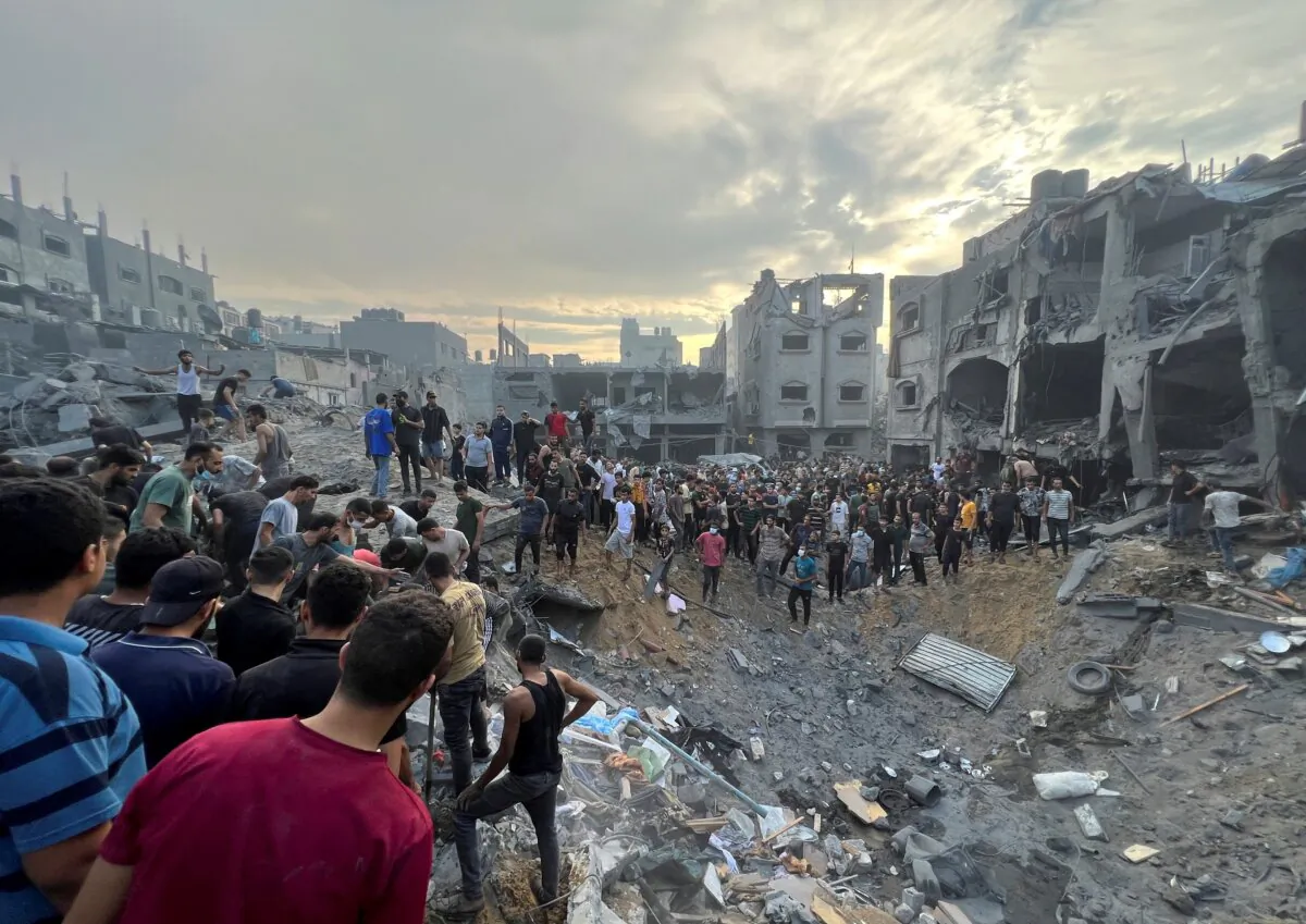 Palestinians search for casualties at the site of Israeli strikes on houses in Jabalia refugee camp in the northern Gaza Strip, on Oct. 31, 2023. (Fadi Whadi/Reuters)