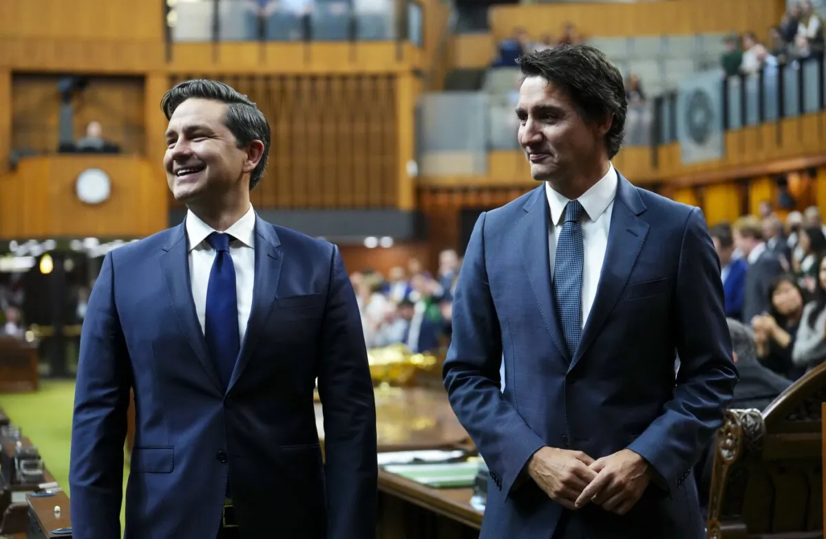 Prime Minister Justin Trudeau (R) and Conservative Leader Pierre Poilievre wait to continue escorting newly elected Speaker of the House of Commons Greg Fergus to his seat, on Parliament Hill in Ottawa, on Oct. 3, 2023. (The Canadian Press/Sean Kilpatrick)
