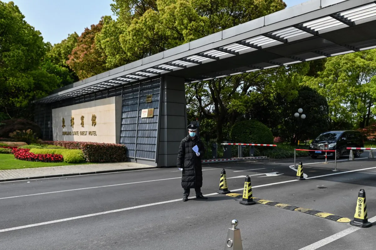 A security guard stands outside the entrance to the Dongjiao State Guest Hotel in Shanghai on April 15, 2021.(Hector Retamal /AFP via Getty Images)