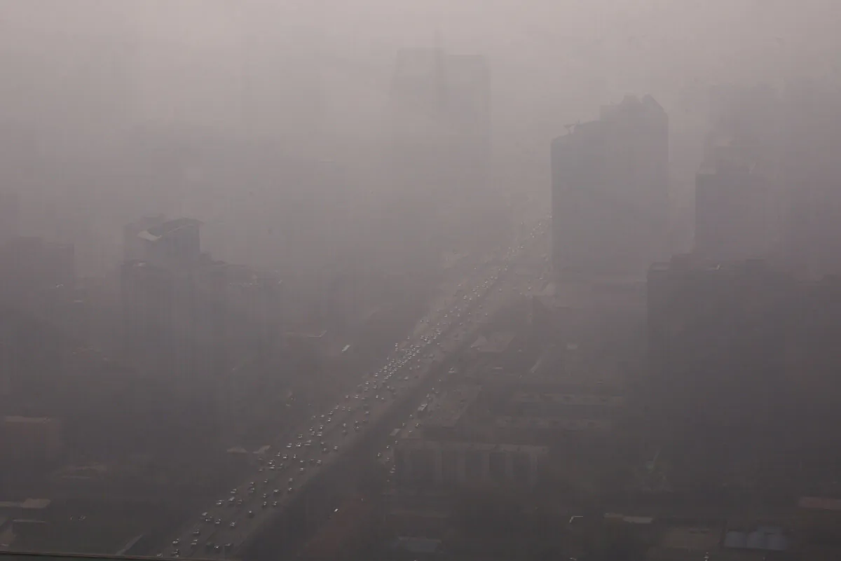 Vehicles move on a street in Beijing's Central Business District (CBD) on Nov. 1, 2023, as the city is shrouded in smog. (Tingshu Wang/Reuters)