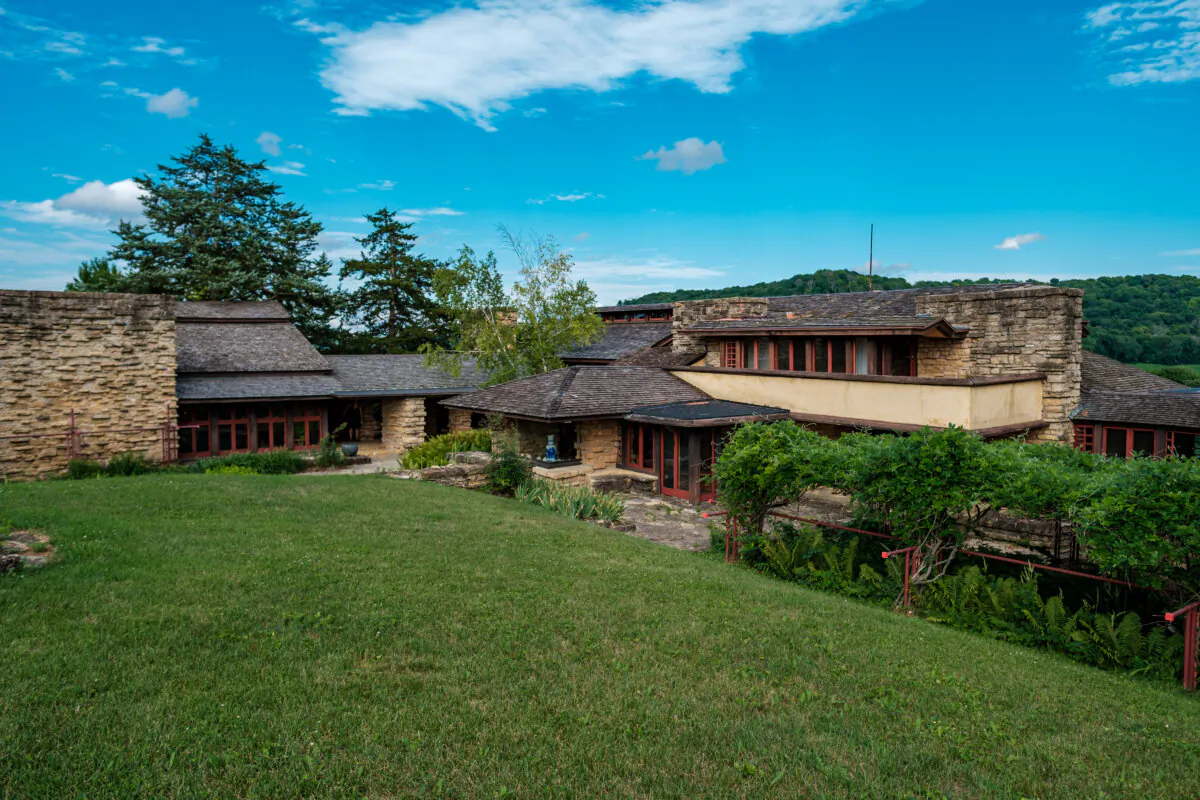 Taliesin sits on a hill. The residential wing and garden court are in keeping with Wright’s theories of organic architecture. He maintained that buildings should be designed to fit into their surroundings rather than stand out from them. The home’s rooflines follow the lines of the hills; its light plaster walls complement the flat stretches of sand in the Lower Wisconsin River below; the weathered, silver-gray roof shingles are a similar hue of oak branches; and, the limestone, quarried less than a mile, mimics the nearby stone outcroppings. Also evident are the cantilever roofs and wide windows. (Courtesy of Taliesin Preservation)