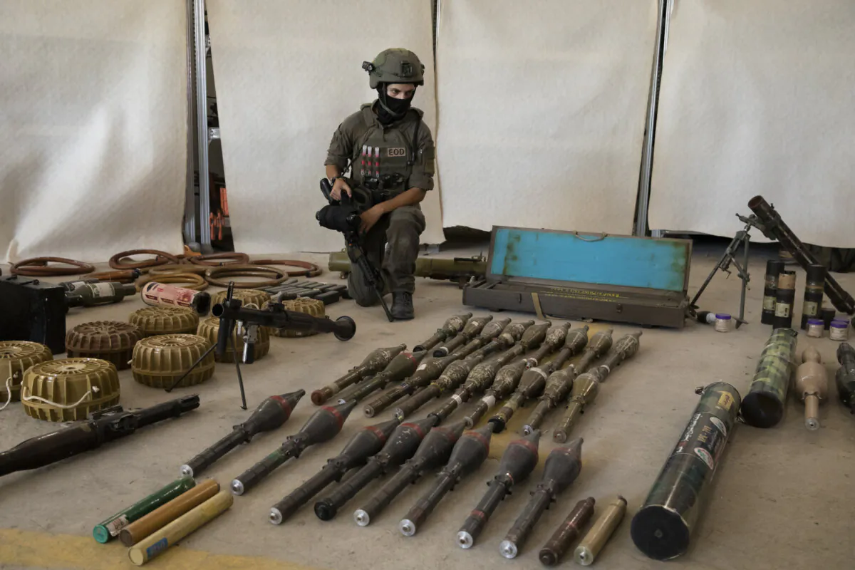 An Israeli soldier displays military equipment and ammunition that Hamas and Palestinians used at the time of the attack on the Israeli south border with the Gaza Strip, in Kiryat Malakhi, Israel, on Oct. 20, 2023. (Amir Levy/Getty Images)