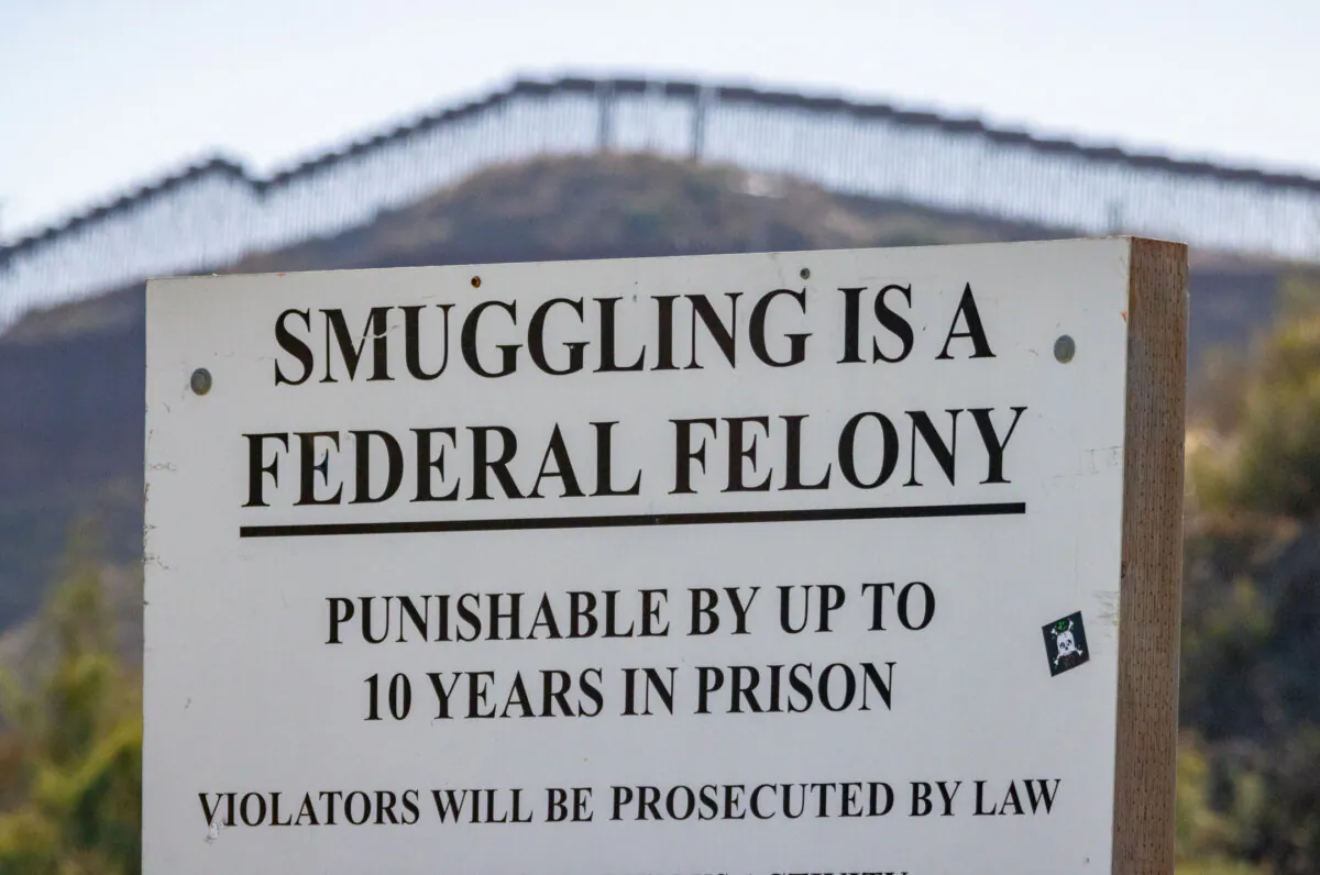A warning sign for smuggling near the United States-Mexico border in San Diego, Calif., on Oct. 31, 2023. (John Fredricks/The Epoch Times)