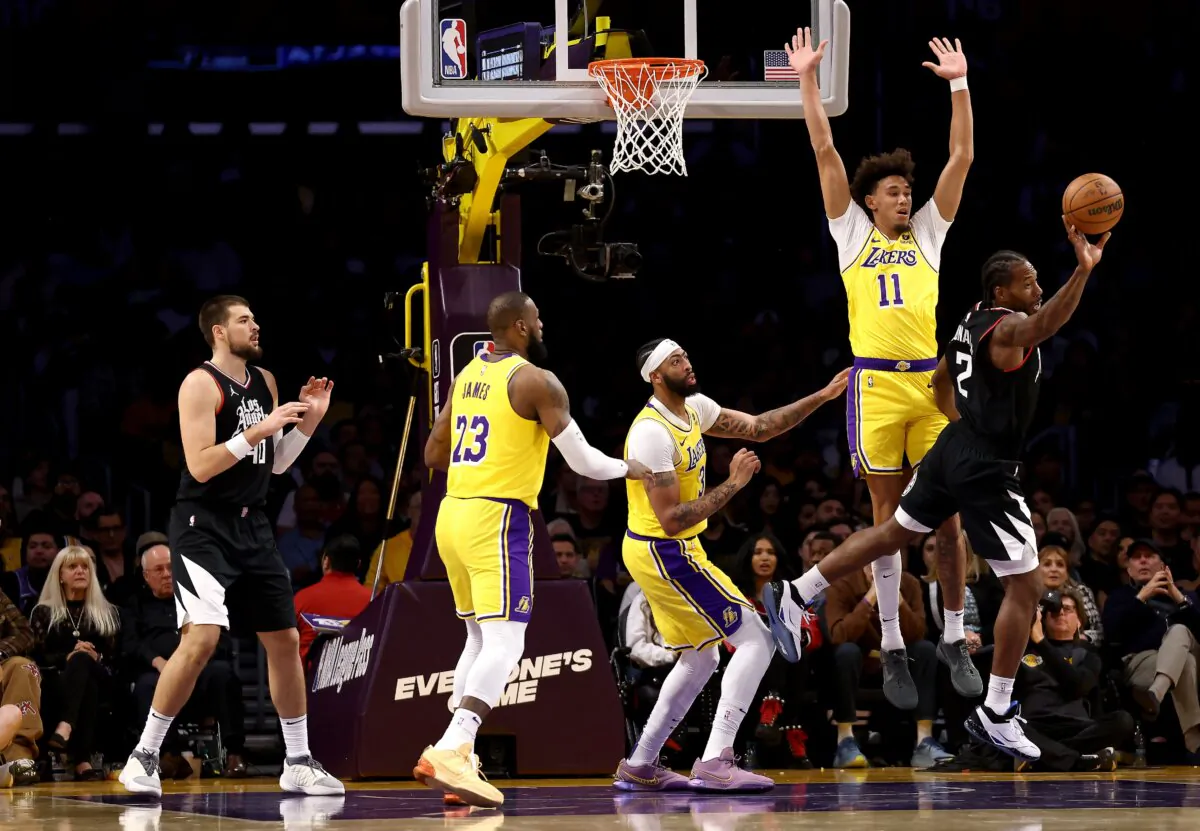 Kawhi Leonard (2) of the Los Angeles Clippers passes the ball against LeBron James (23), Anthony Davis (3), and Jaxson Hayes (11) of the Los Angeles Lakers during the second quarter in Los Angeles on Nov. 1, 2023. (Katelyn Mulcahy/Getty Images)